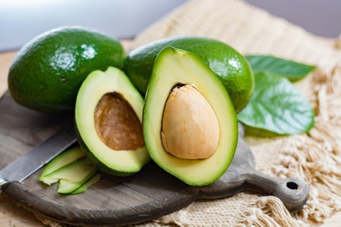 Avocados liegen aufgeschnitten auf einem Brett