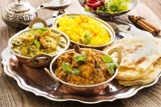 Einige indische Gerichte stehen auf einem Tisch nebeneinander