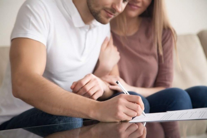 Ein Elternpaar macht eine Liste für eine konsequente Erziehung