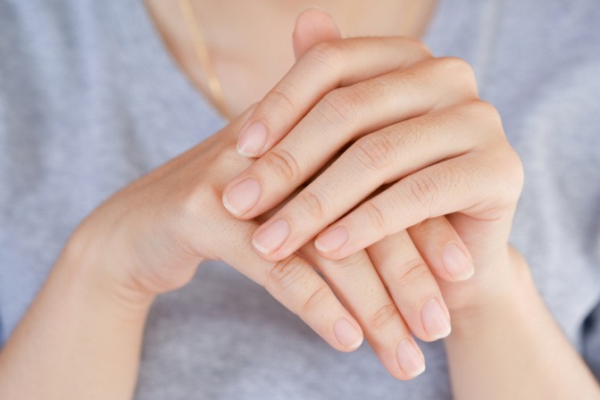 Eine Hand mit gepflegten Nägeln hält eine Nagelfeile