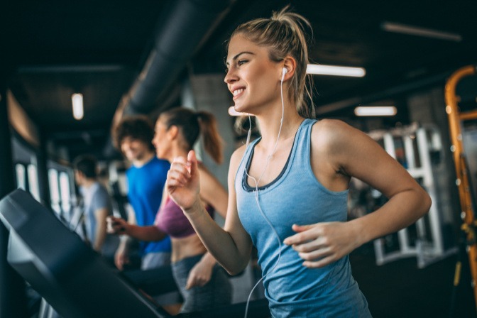 Frau auf dem Laufband im Fitnessstudio mit Make-up