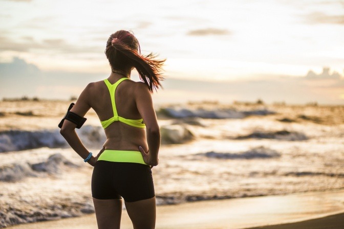 Eine Frau macht Sport am Strand im Sommer