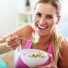 Eine Frau isst neben Sport vegane Ernährung