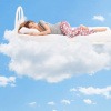 Frau im Bett auf Wolken