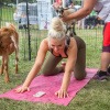 Frau macht mit Ziegen Yoga