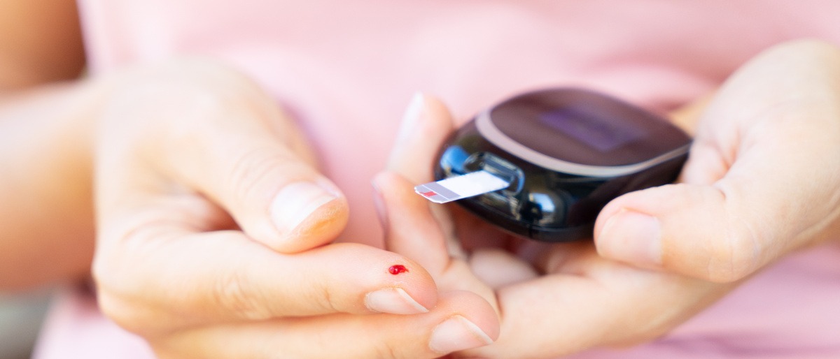 Eine Frau mit Diabetes ist beim Blutzucker messen