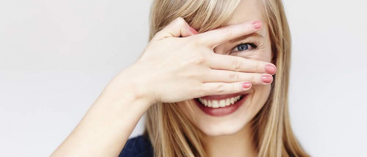 Eine Frau schaut durch ihre Finger