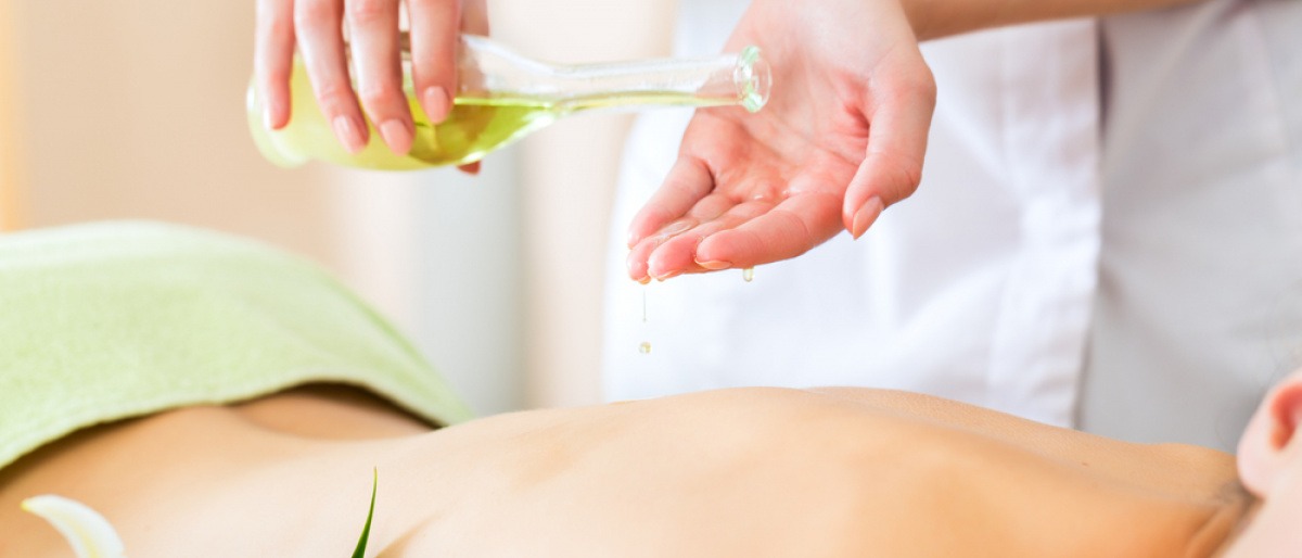 Eine Frau erhält eine Massage mit Massageölen