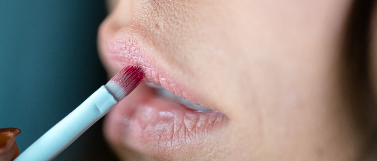 Eine Frau trägt einen Lippenstift auf