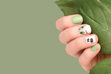 Frauenhand mit grünen Fingernägel im Iced Matcha Nails Trend