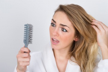 Die Haare einer Frau brechen ab