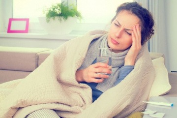 Eine Frau hat hormonelle Migräne und greift ihren Kopf an