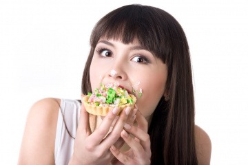 Eine Frau isst Lebensmittel, die Pickel verursachen