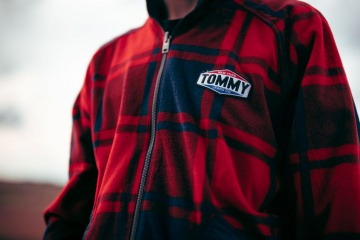 Ein Mann trägt einen Sweater von Tommy Hilfiger